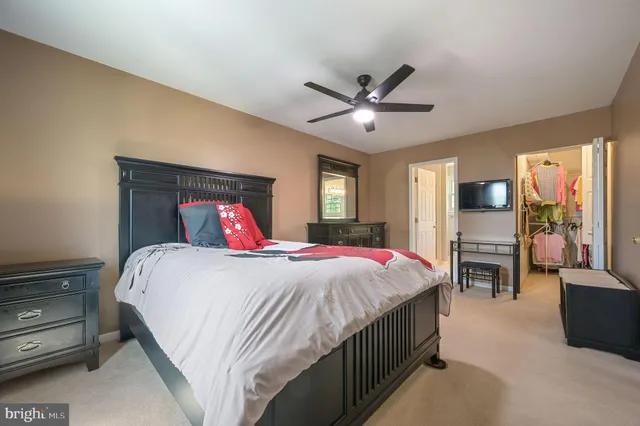 a bedroom with a large bed and a tv