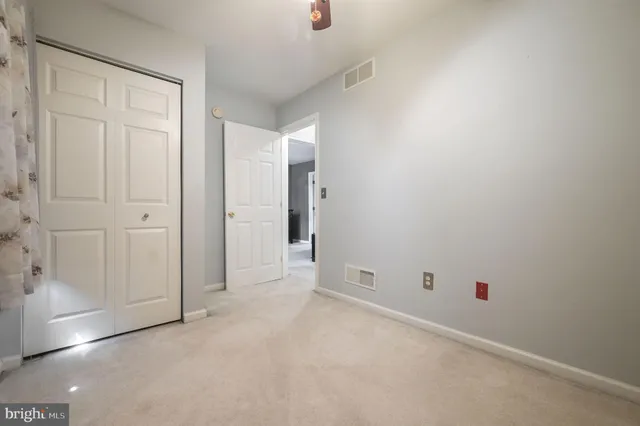 an empty room with windows and closet