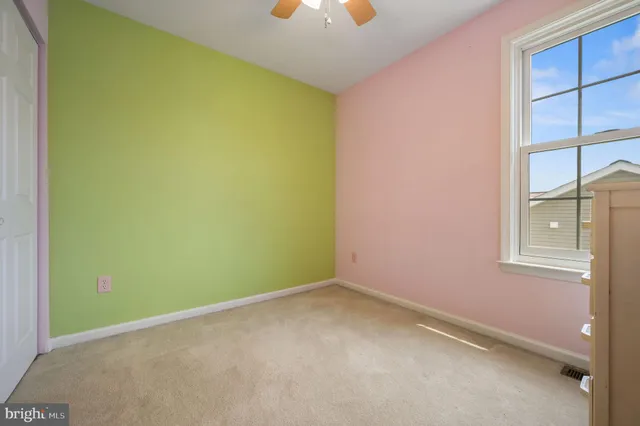 an empty room with windows and closet