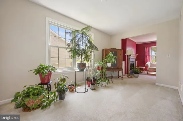 a lobby with furniture and potted plants