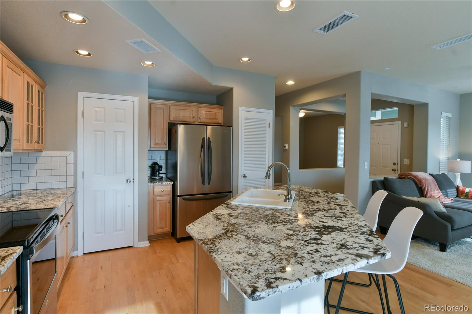 156 Whitehaven Circle Highlands Ranch, CO 80129 - Photo 11 of 30 a dining hall with stainless steel appliances granite countertop a table and chairs