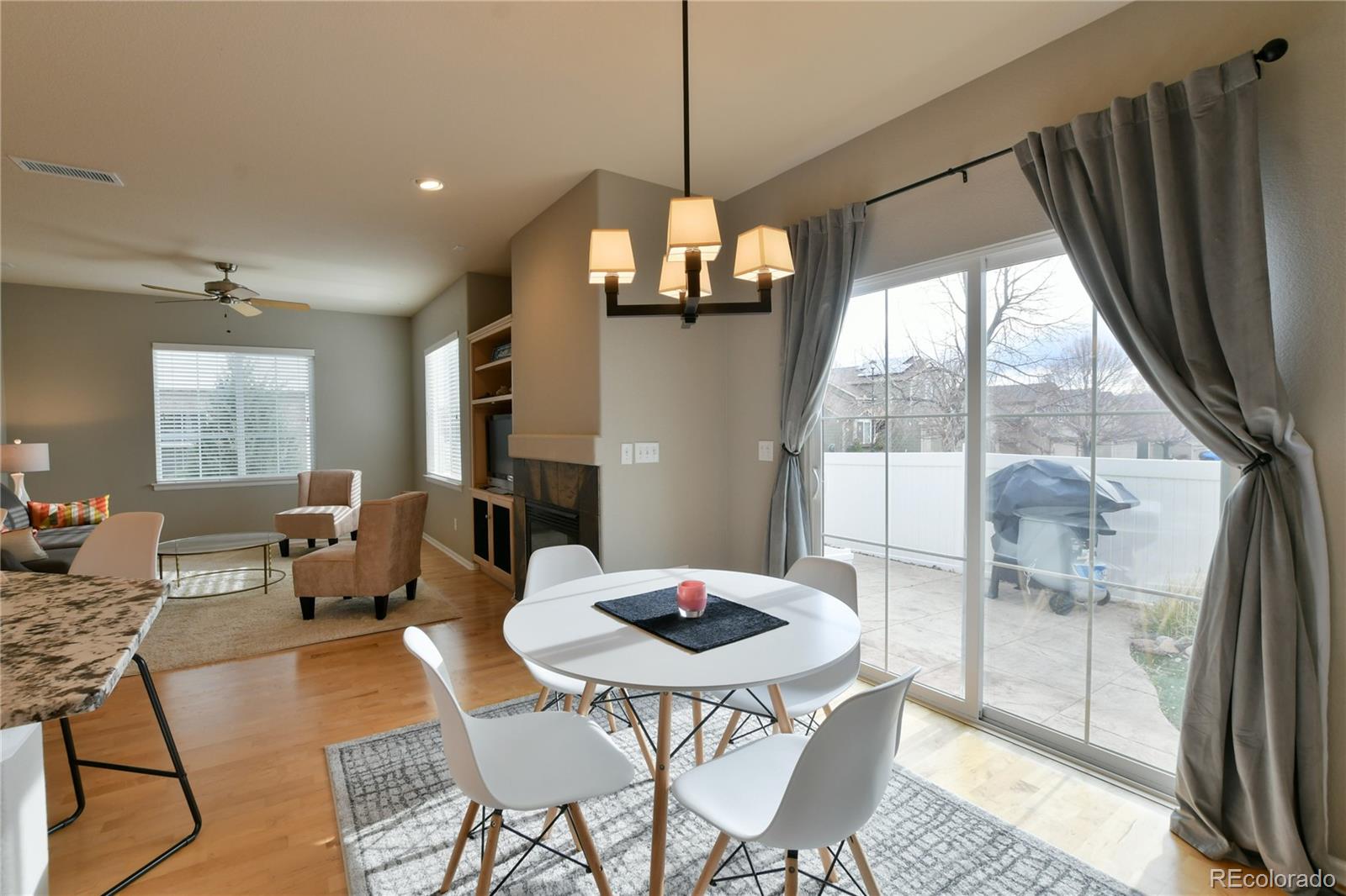 156 Whitehaven Circle Highlands Ranch, CO 80129 - Photo 7 of 30 a view of a dining room with furniture window and wooden floor