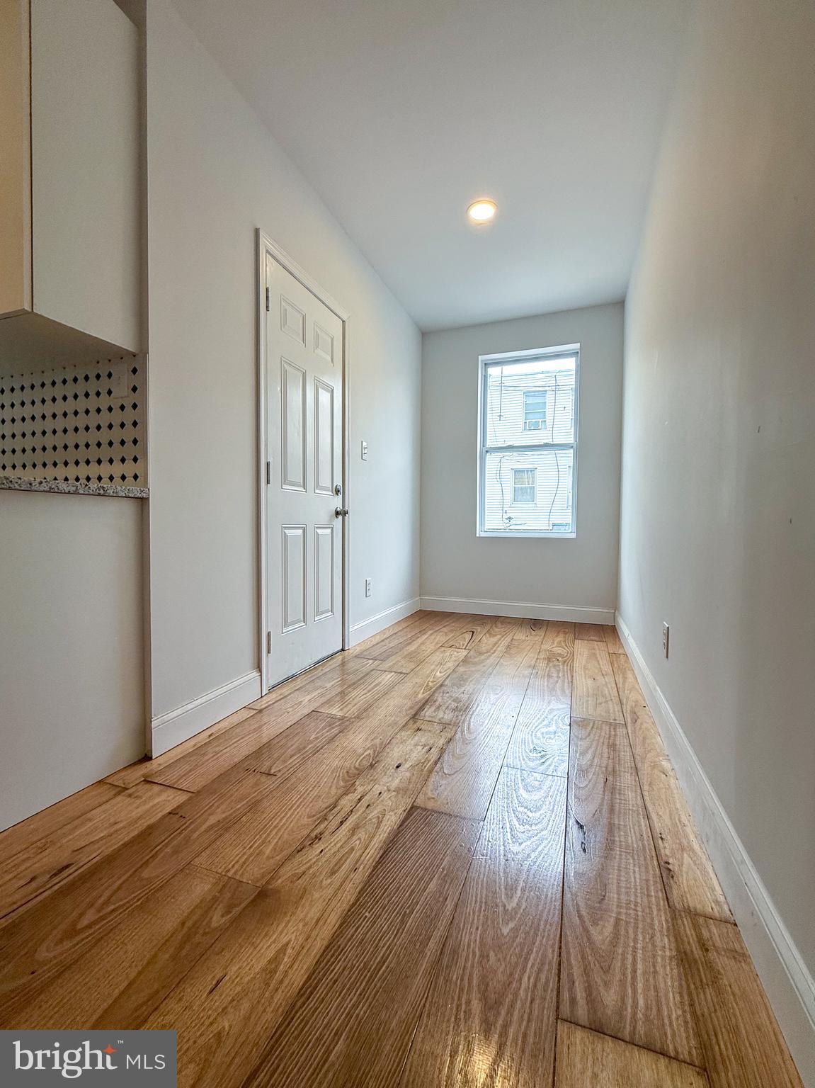 2079 Anchor Street Philadelphia, PA 19124 - Photo 13 of 26 an empty room with wooden floor and windows