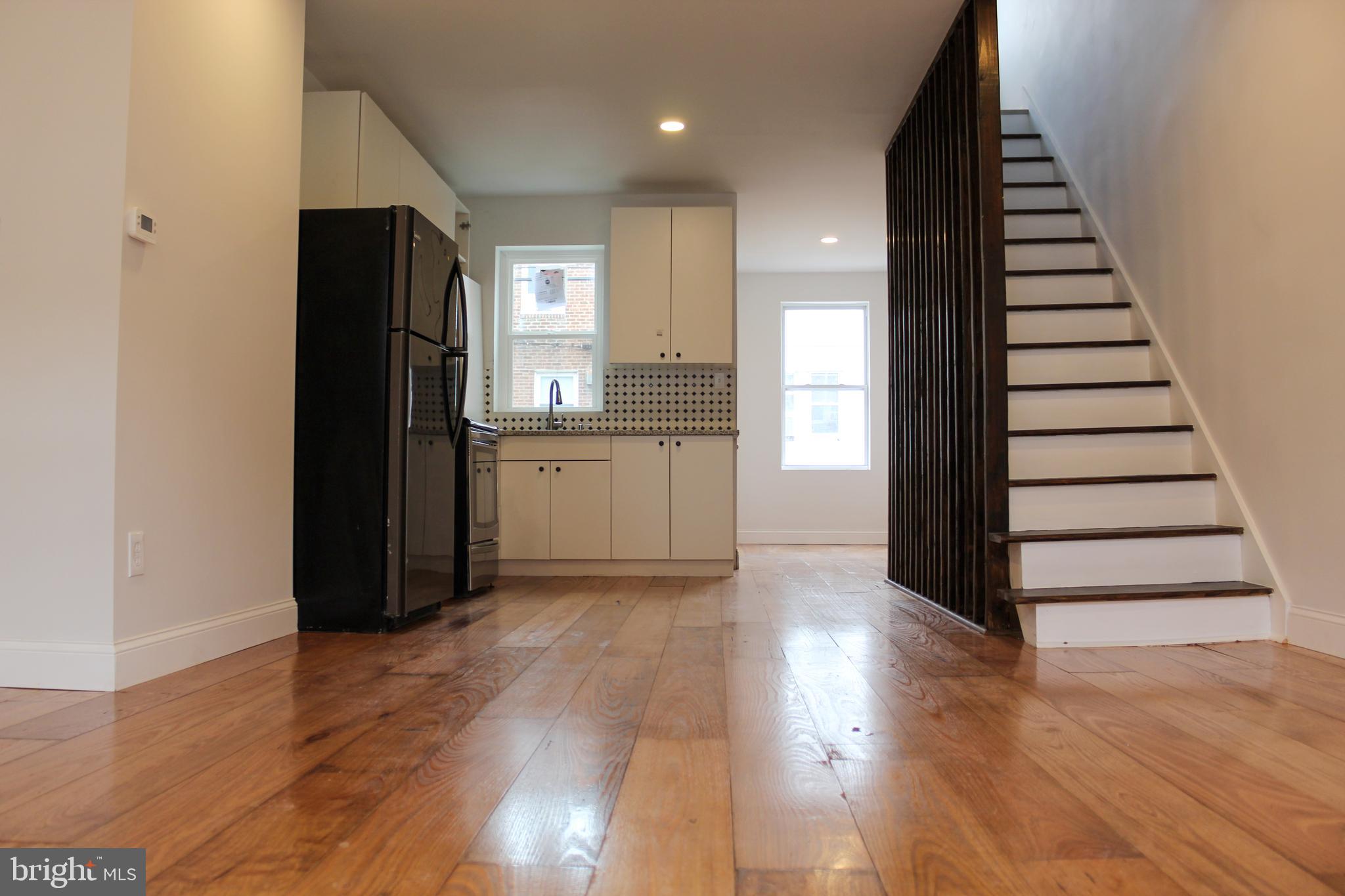 2079 Anchor Street Philadelphia, PA 19124 - Photo 4 of 26 a view of a kitchen with wooden floor and stairs