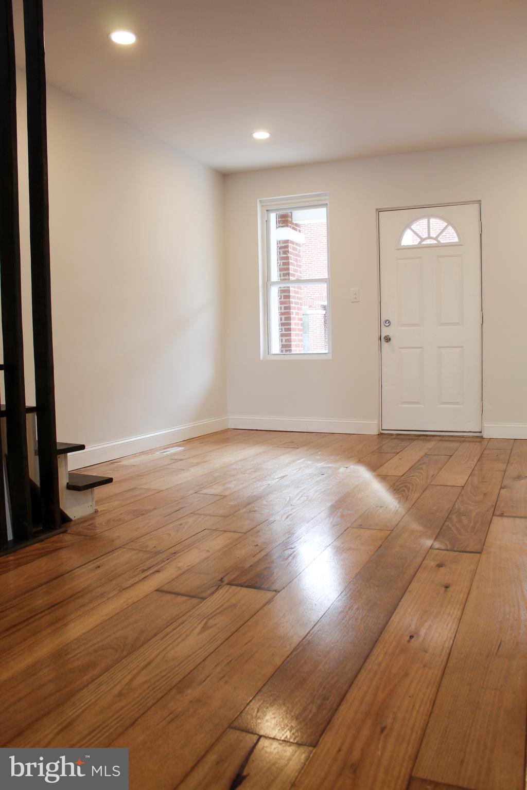 2079 Anchor Street Philadelphia, PA 19124 - Photo 10 of 26 an empty room with wooden floor and windows