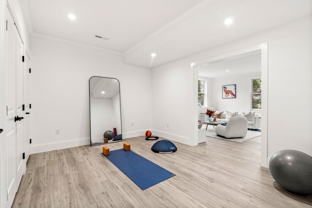 39 Donna Road Needham, MA 02494 - Photo 36 of 42 a room with wooden floor and gym equipment