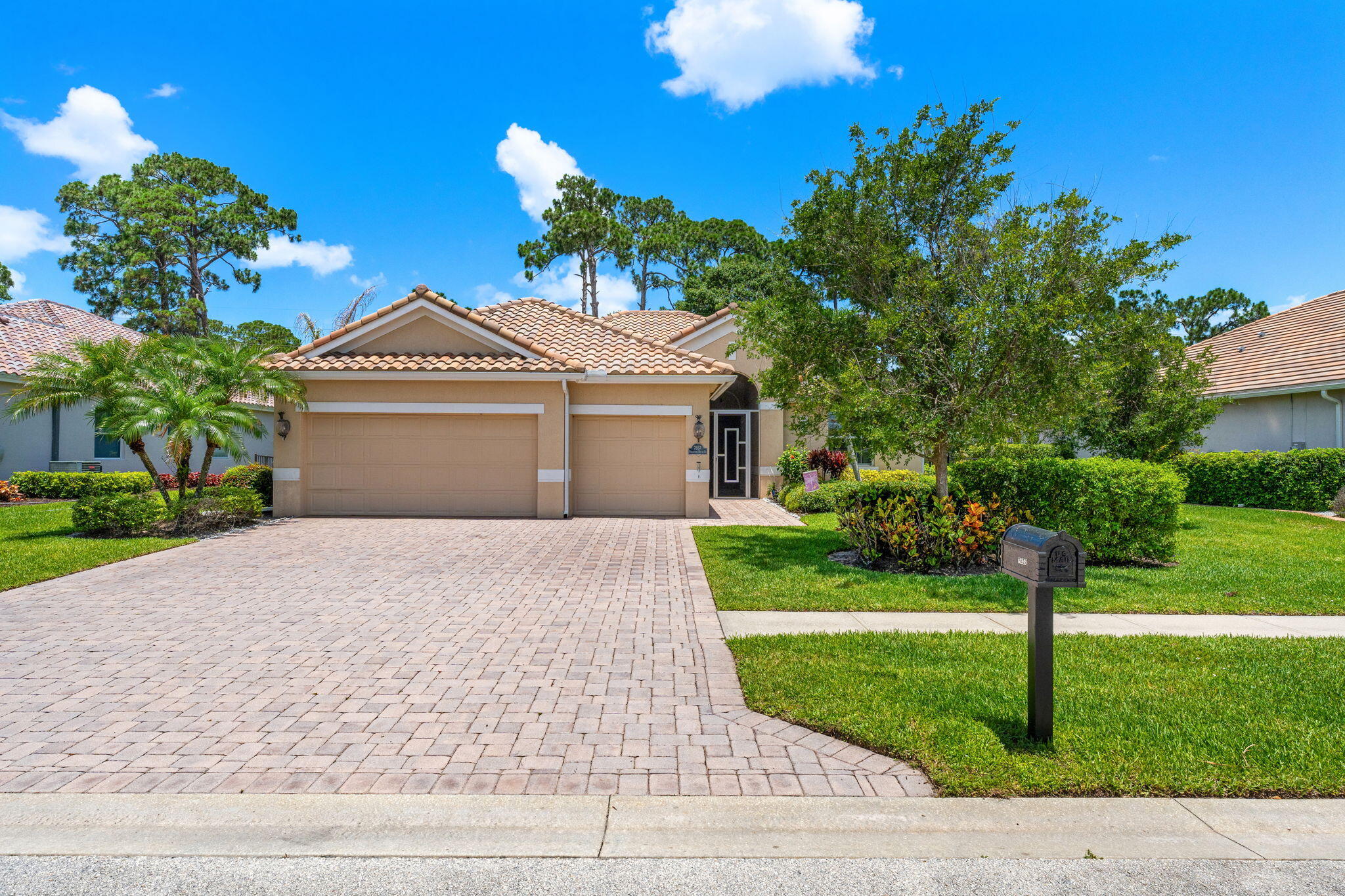 7657 Fieldstone Ranch Square Vero Beach, FL 32967 - Photo 44 of 52 a front view of a house with a garden and yard