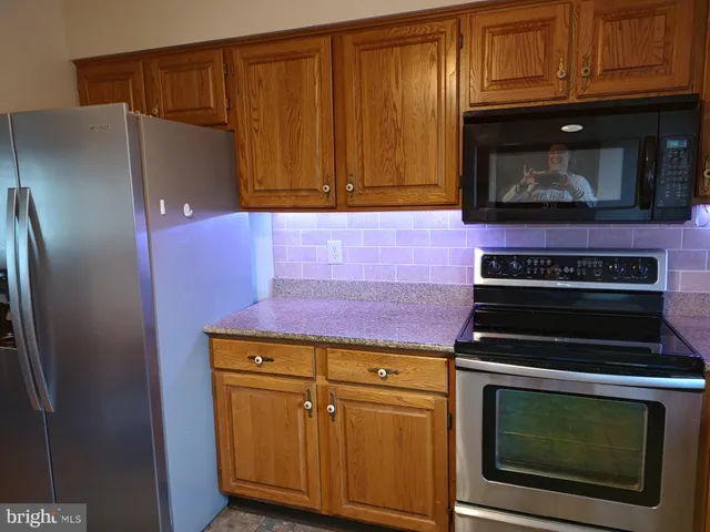 a view of a microwave and cabinets