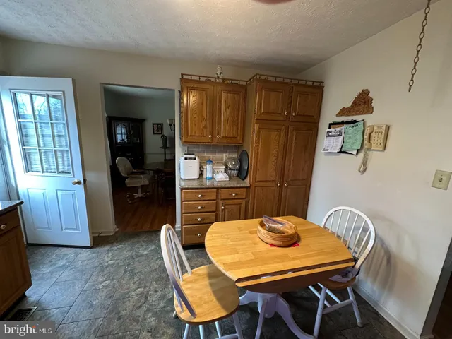 a kitchen with a table chairs and a refrigerator