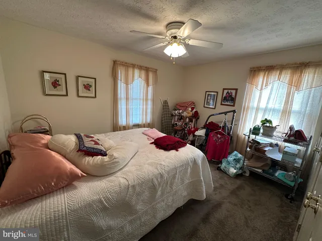 a bedroom with bed a large bed and a chandelier