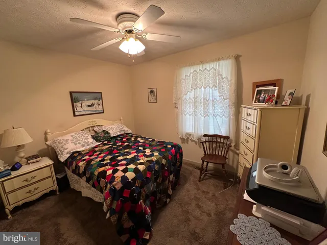 a bedroom with bed and a window