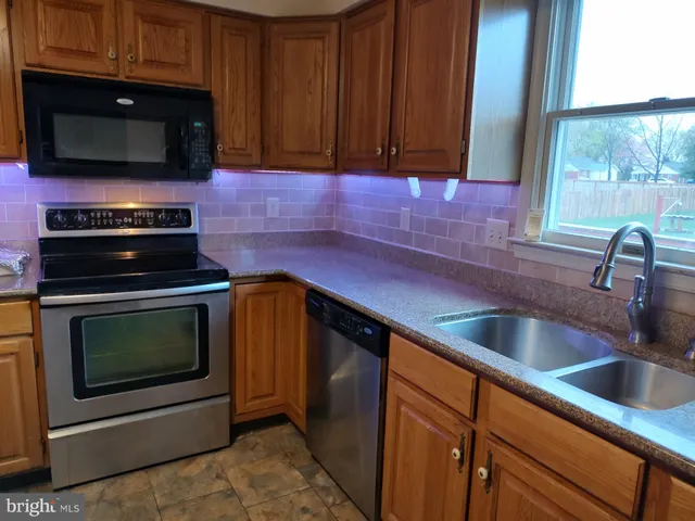 a kitchen with a sink stove and microwave