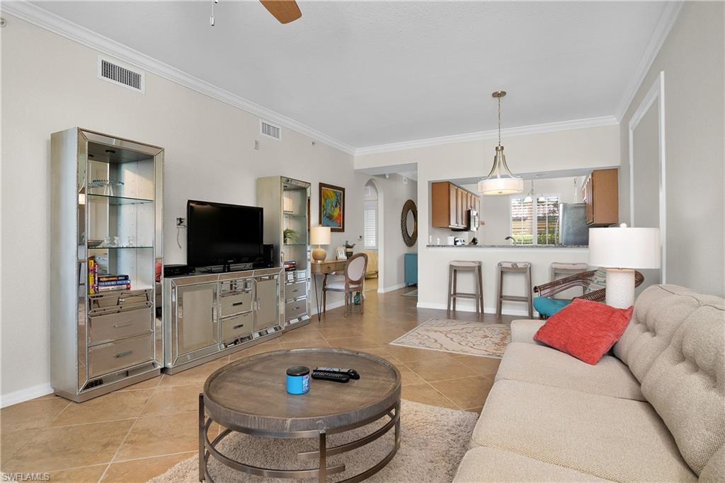 9719 Acqua Court, Unit 214 Naples, FL 34113 - Photo 5 of 50 a living room with furniture and a flat screen tv