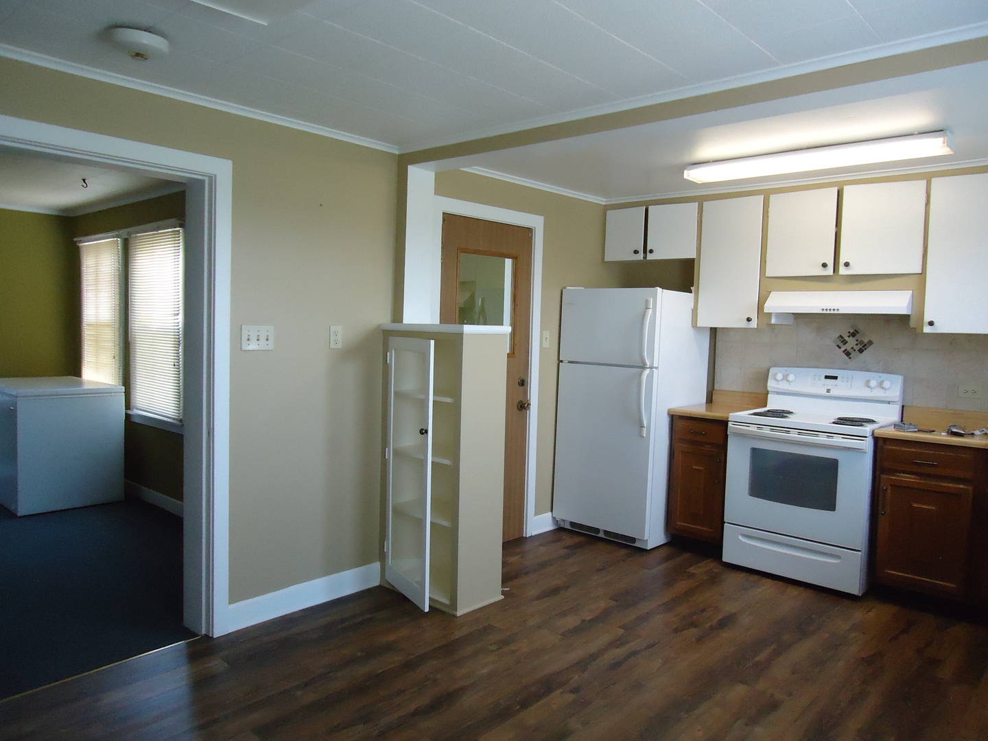 792 North 15th Road Lostant, IL 61334 - Photo 4 of 31 a kitchen with a refrigerator and a stove top oven