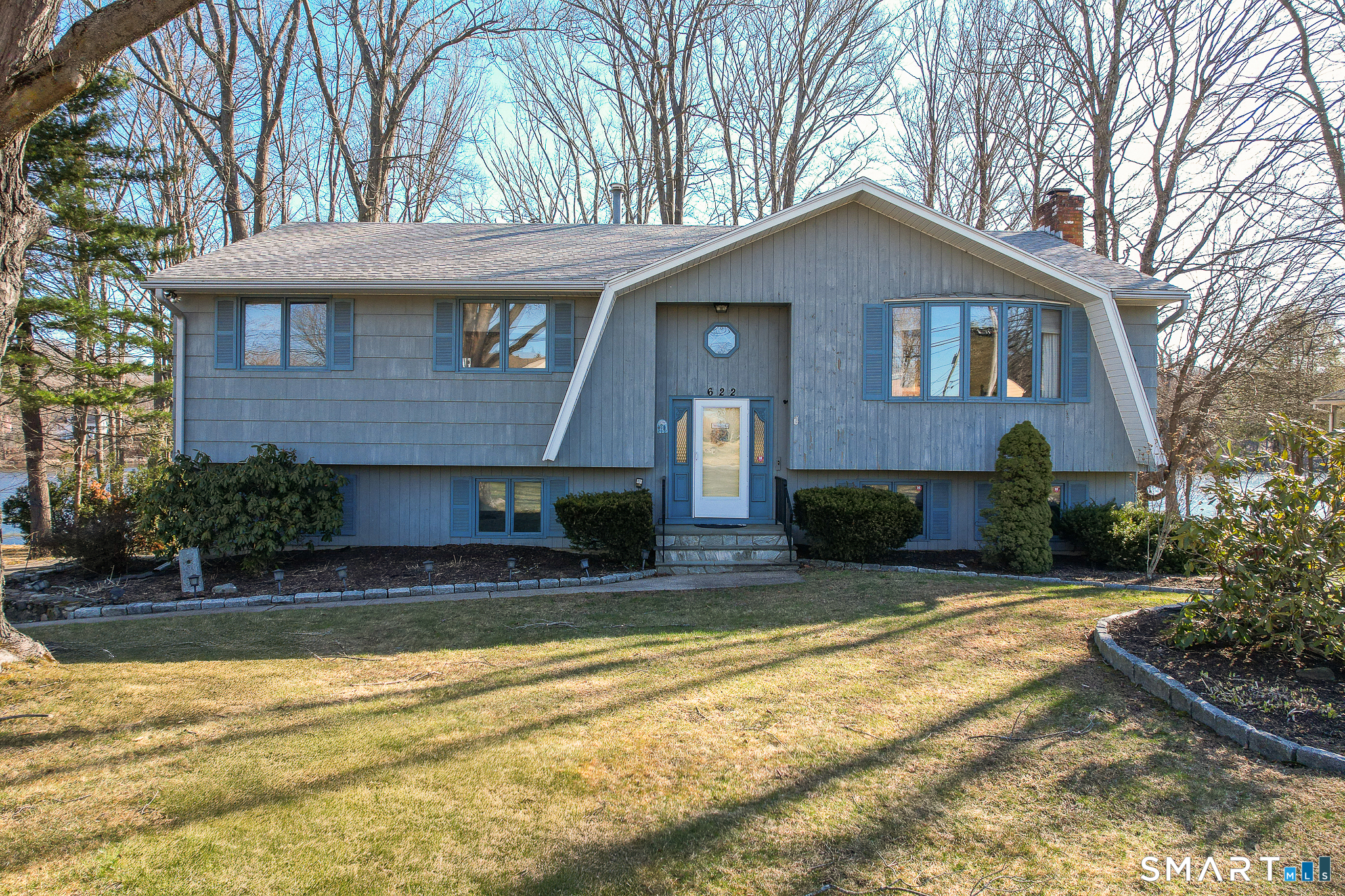 622 Lakeside Boulevard West Waterbury, CT 06708 - Photo 2 of 40 a front view of a house with a yard outdoor seating and garage