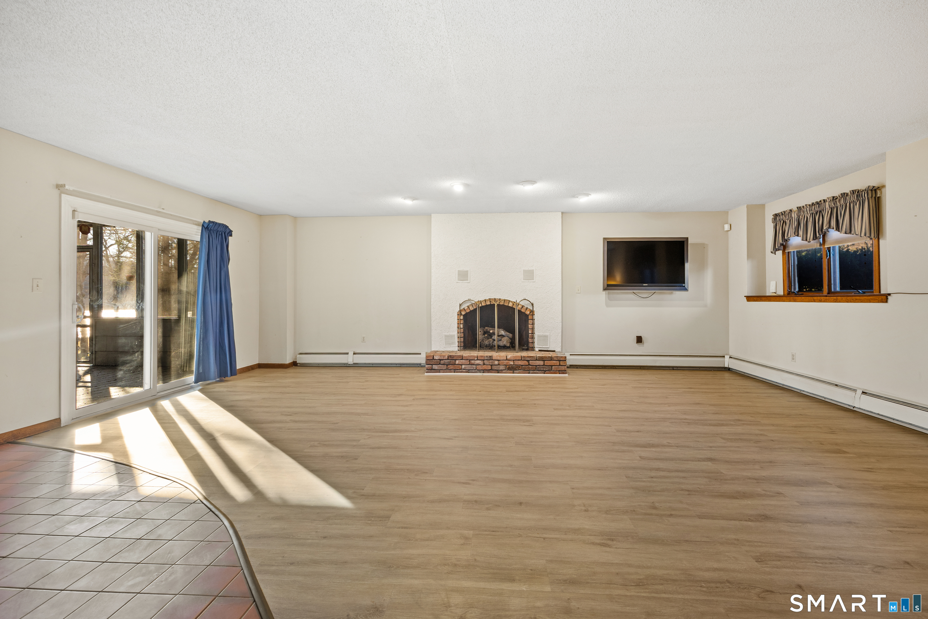 622 Lakeside Boulevard West Waterbury, CT 06708 - Photo 27 of 40 a big room with wooden floor and a large window