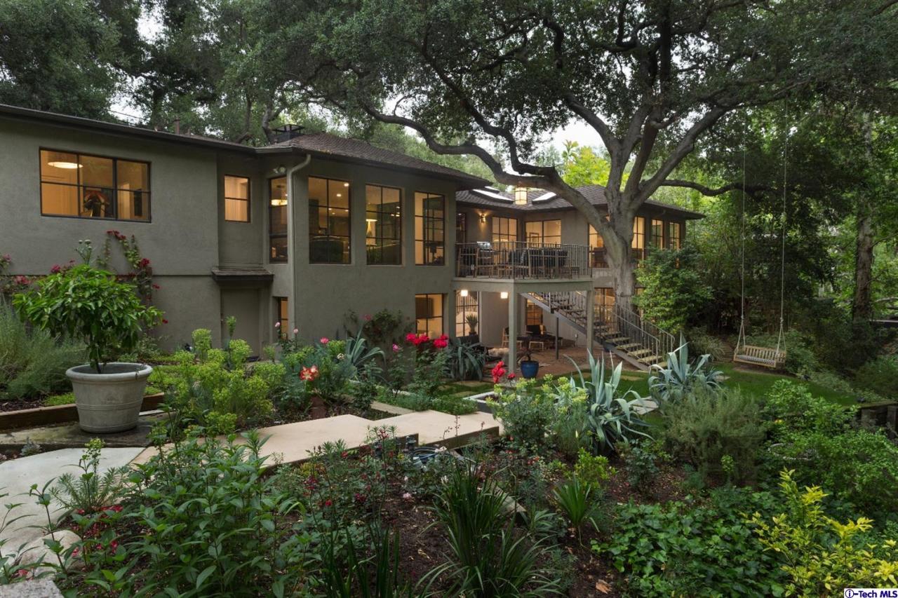 885 Laguna Road Pasadena, CA 91105 - Photo 2 of 33 a front view of a house with a yard and potted plants