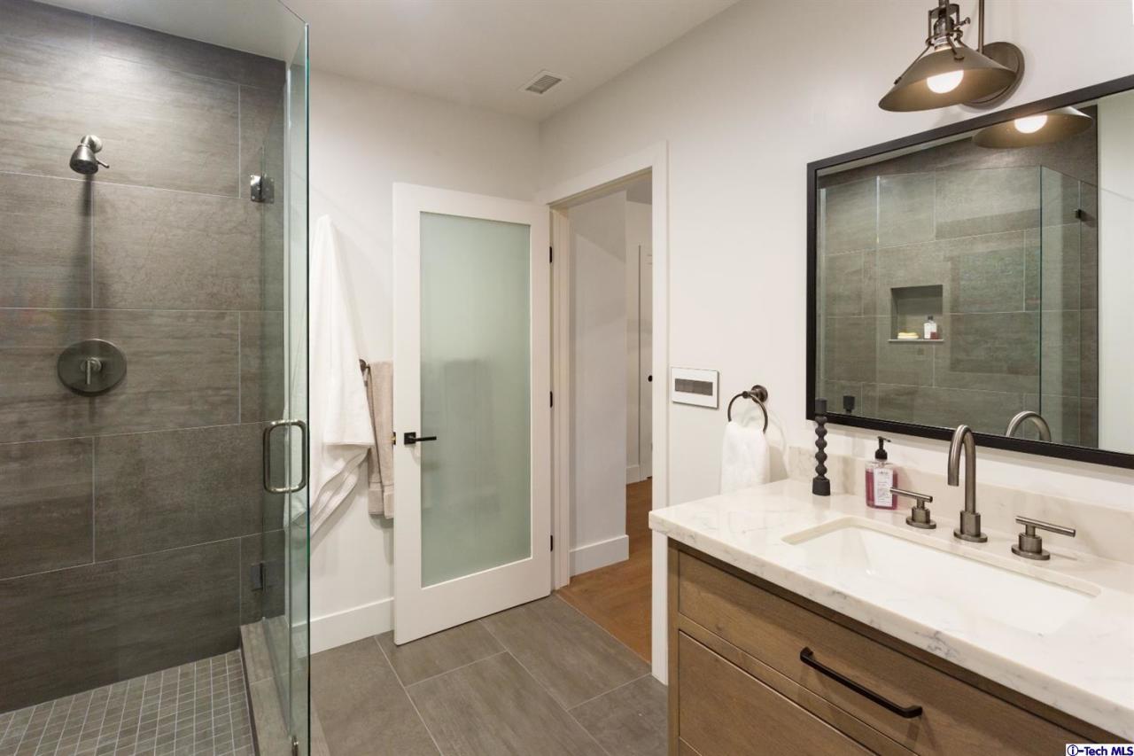 885 Laguna Road Pasadena, CA 91105 - Photo 16 of 33 a bathroom with a granite countertop sink shower and a mirror
