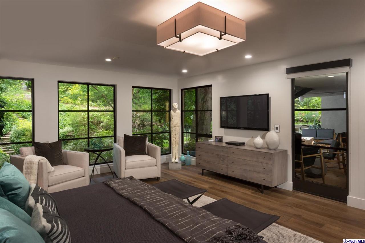 885 Laguna Road Pasadena, CA 91105 - Photo 22 of 33 a living room with furniture and a flat screen tv