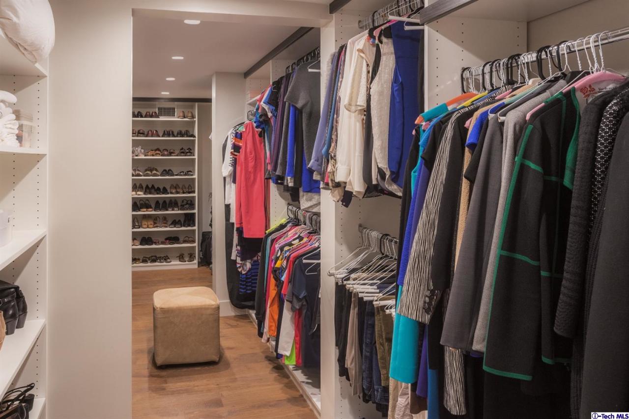 885 Laguna Road Pasadena, CA 91105 - Photo 25 of 33 a view of walk in closet with clothes and shoes