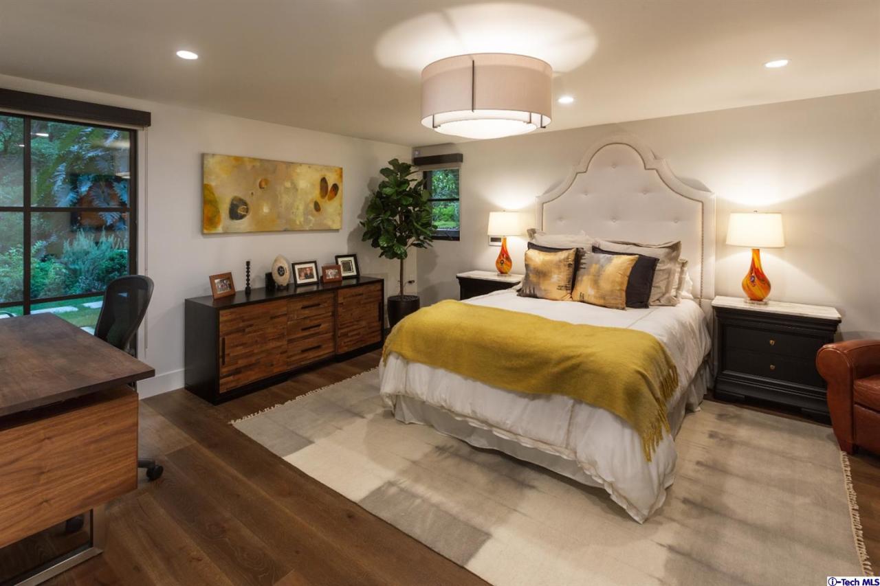 885 Laguna Road Pasadena, CA 91105 - Photo 26 of 33 a spacious bedroom with a bed and a chandelier
