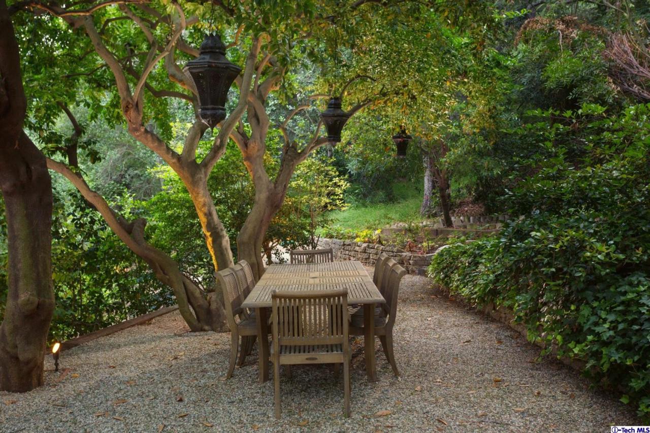 885 Laguna Road Pasadena, CA 91105 - Photo 32 of 33 a backyard of a house with table and chairs