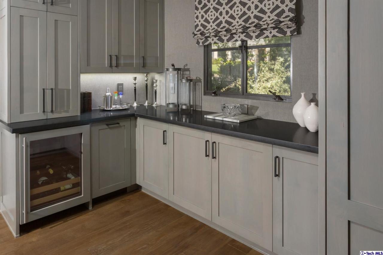 885 Laguna Road Pasadena, CA 91105 - Photo 9 of 33 a kitchen with granite countertop a sink a stove and cabinets