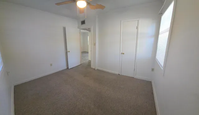 an empty room with closet area