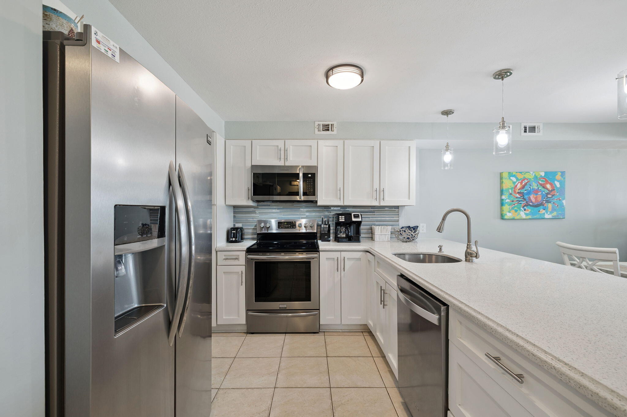23223 Front Beach Road, Unit C3201 Panama City Beach, FL 32413 - Photo 11 of 45 a kitchen with a sink stainless steel appliances and cabinets