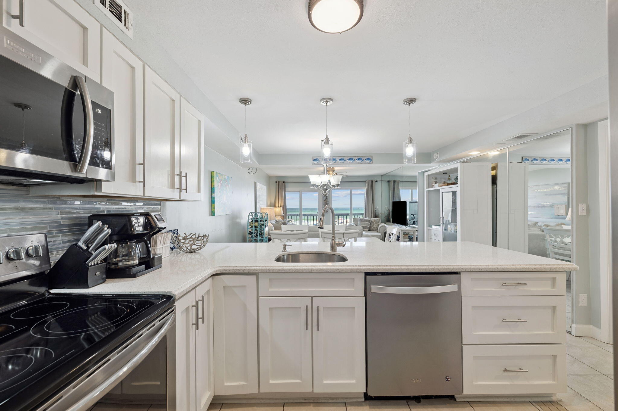 23223 Front Beach Road, Unit C3201 Panama City Beach, FL 32413 - Photo 12 of 45 a kitchen with counter top space appliances and cabinets
