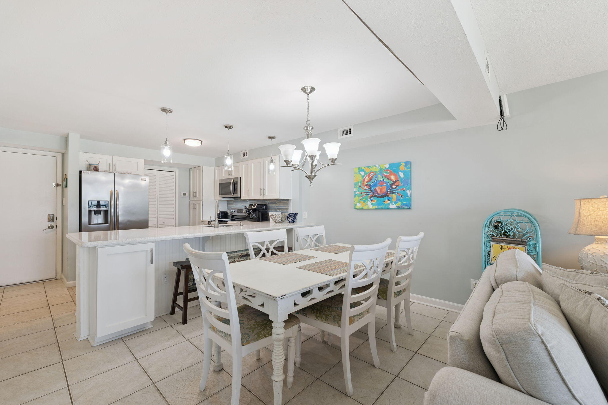 23223 Front Beach Road, Unit C3201 Panama City Beach, FL 32413 - Photo 17 of 45 a view of a dining room with furniture and chandelier