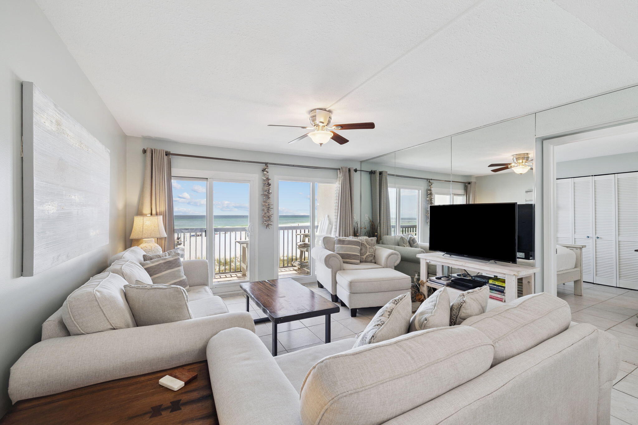 23223 Front Beach Road, Unit C3201 Panama City Beach, FL 32413 - Photo 20 of 45 a living room with furniture and a flat screen tv