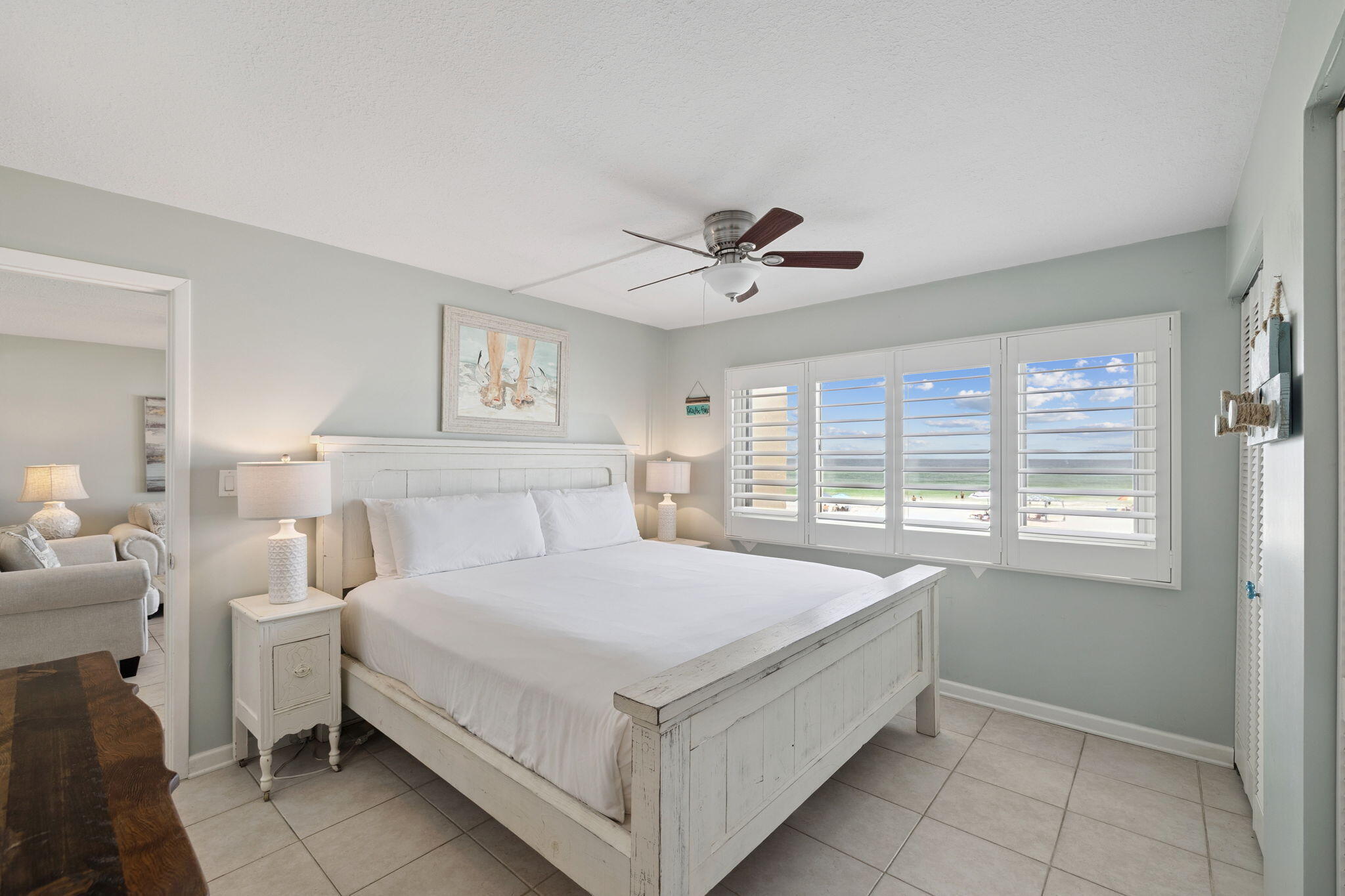 23223 Front Beach Road, Unit C3201 Panama City Beach, FL 32413 - Photo 32 of 45 a spacious bedroom with a bed and a chandelier