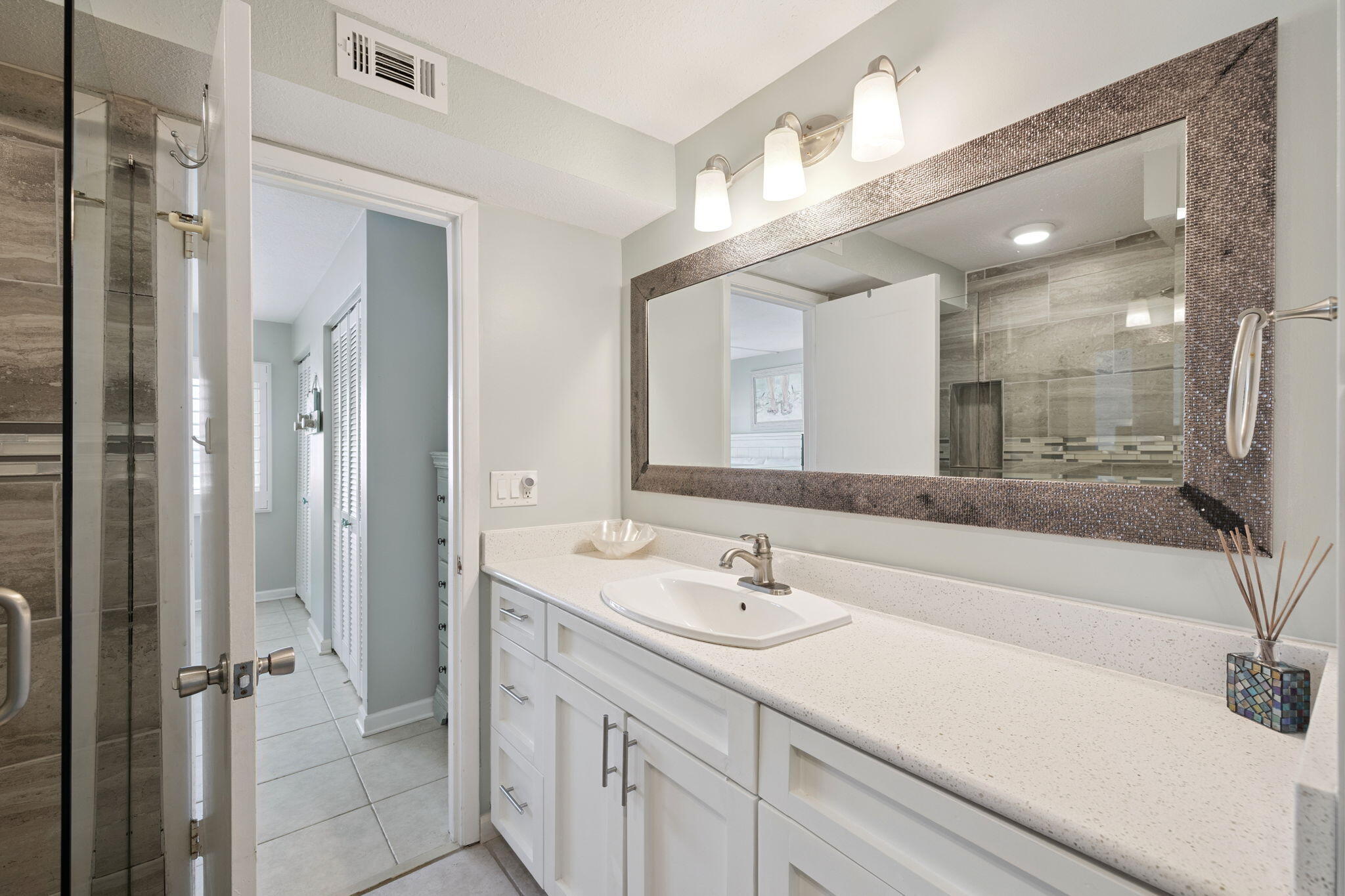 23223 Front Beach Road, Unit C3201 Panama City Beach, FL 32413 - Photo 35 of 45 a bathroom with a sink double vanity and a mirror