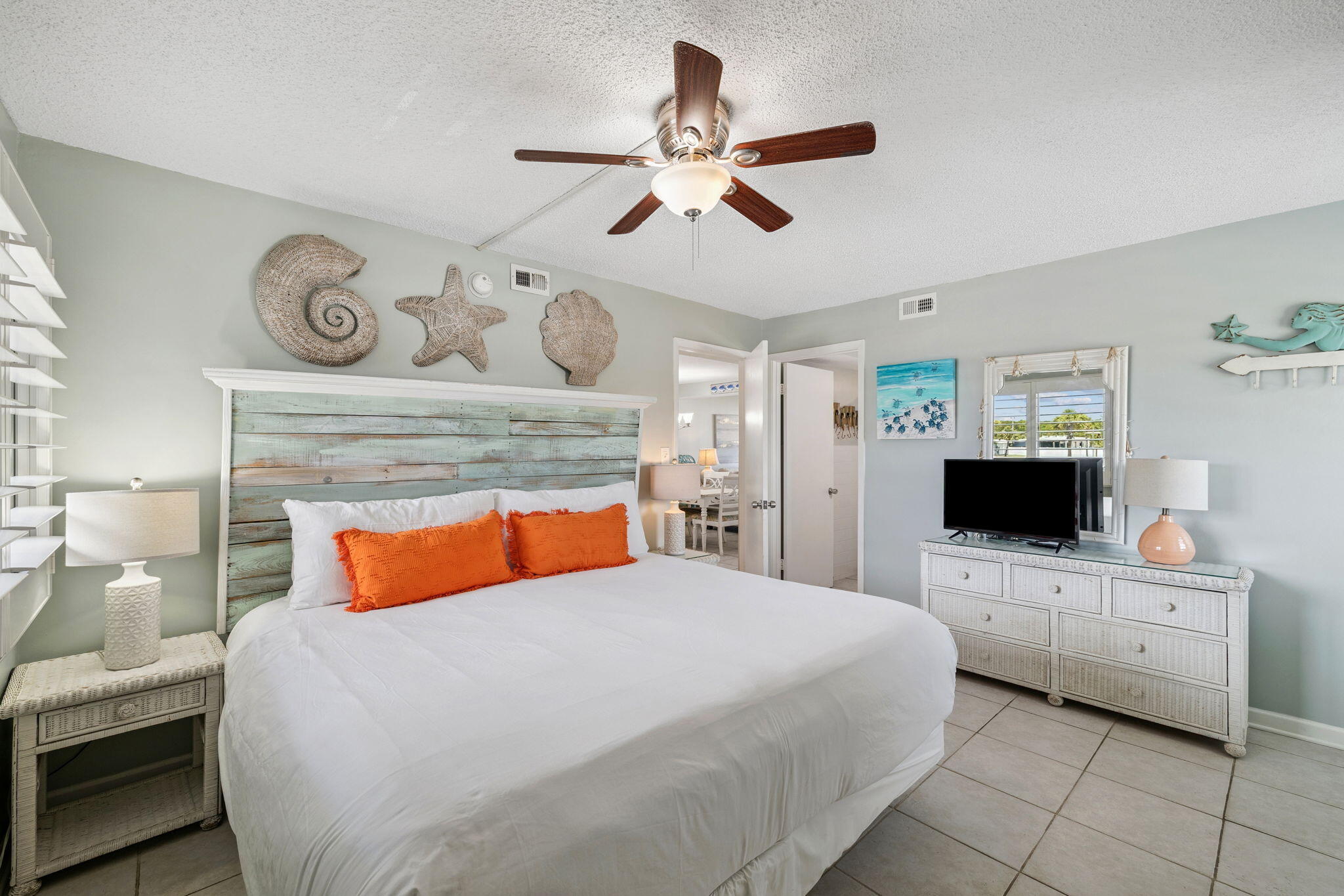 23223 Front Beach Road, Unit C3201 Panama City Beach, FL 32413 - Photo 6 of 45 a bedroom with a bed and a chandelier