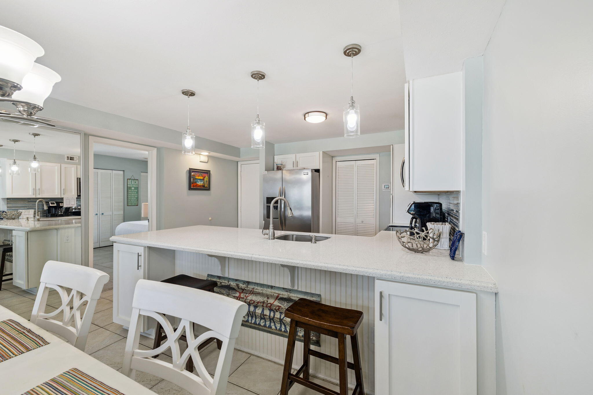 23223 Front Beach Road, Unit C3201 Panama City Beach, FL 32413 - Photo 9 of 45 a kitchen with a sink cabinets and wooden floor
