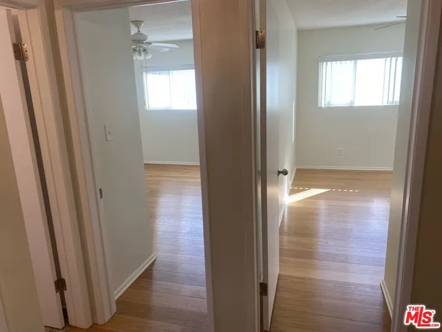 a view of hallway with wooden floor