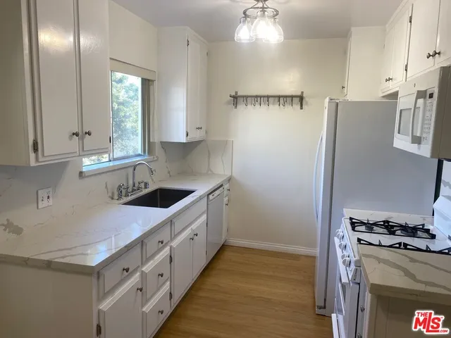 a kitchen with cabinets and stainless steel appliances