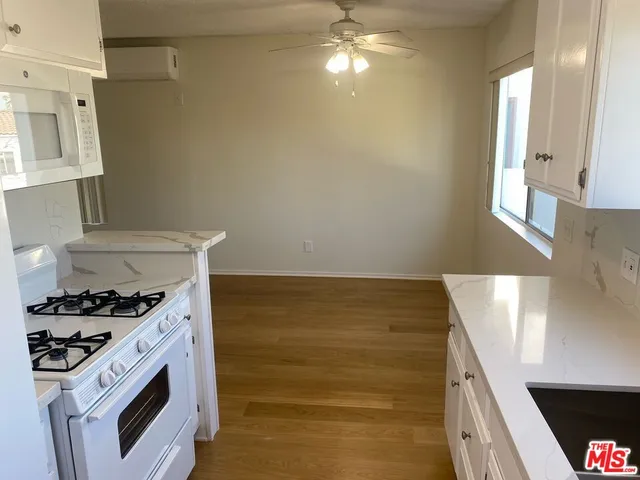 a kitchen with a stove and a white cabinet