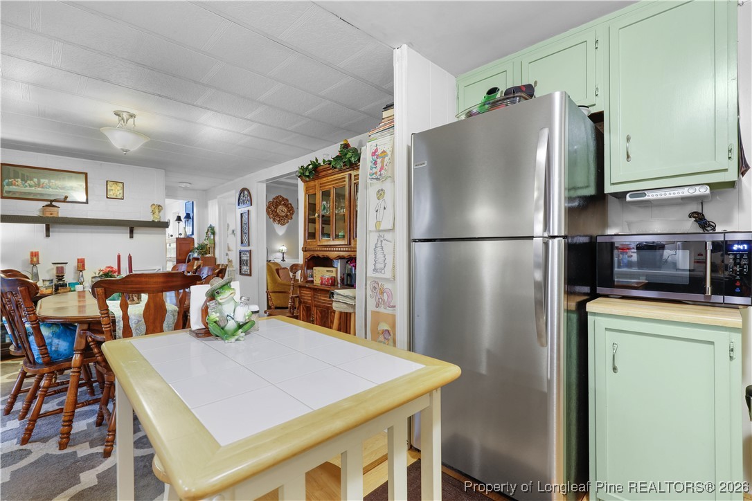 156 Connell Road Carthage, NC 28327 - Photo 9 of 43 a kitchen with stainless steel appliances a refrigerator a stove a sink a dining table and chairs