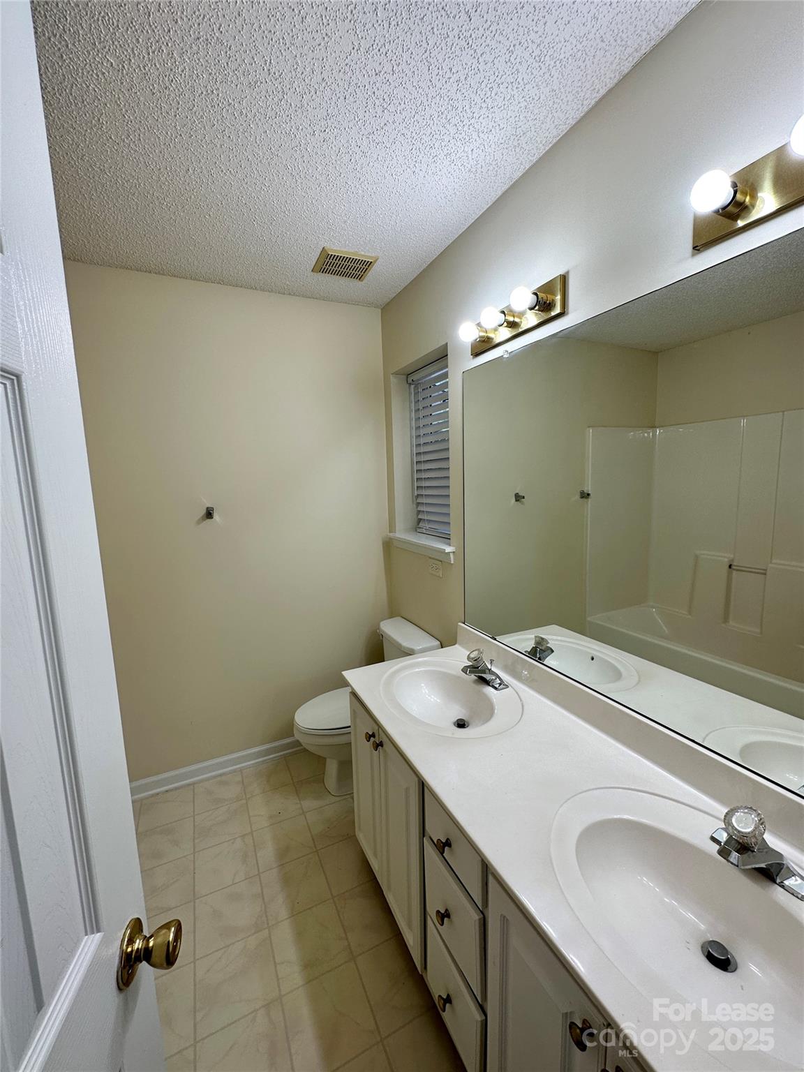 8348 Rudolph Road Charlotte, NC 28216 - Photo 12 of 14 a bathroom with a sink and a mirror