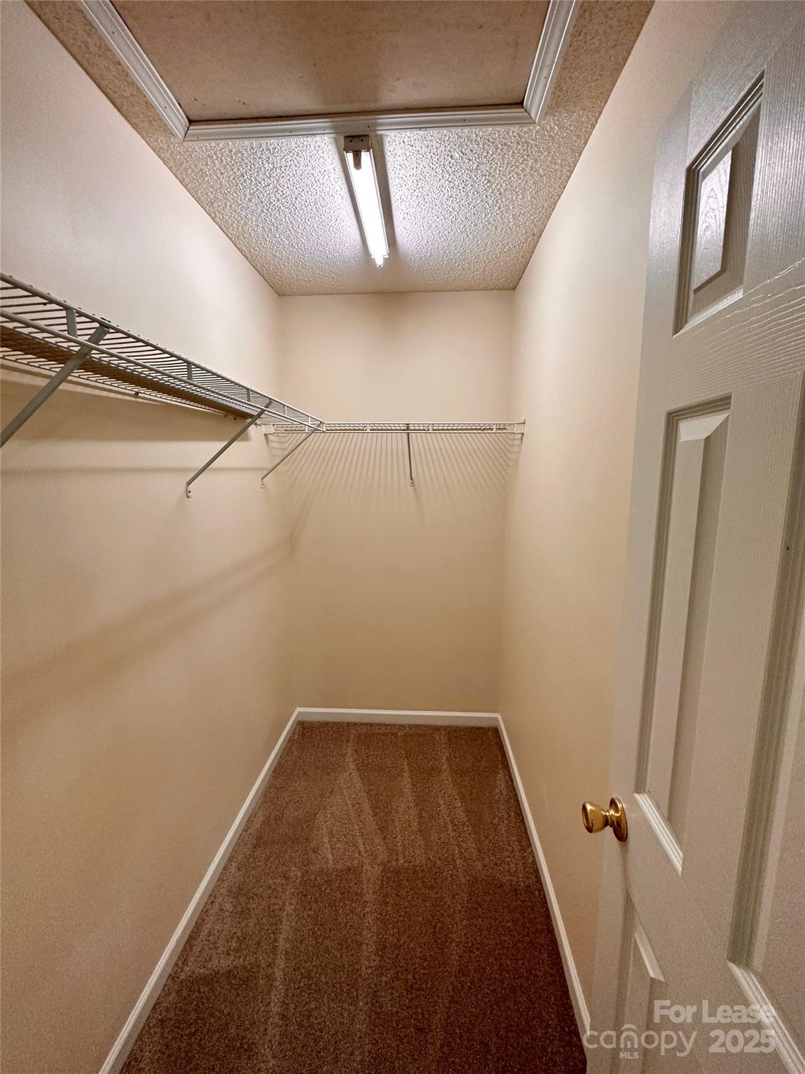 8348 Rudolph Road Charlotte, NC 28216 - Photo 13 of 14 a view of a room with racks on the wall