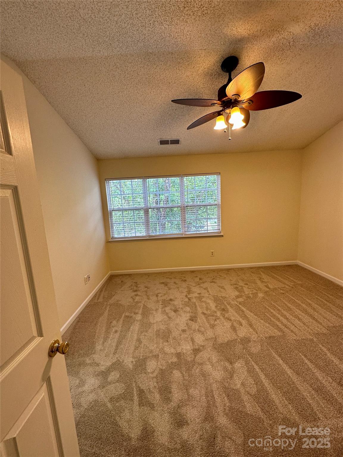 8348 Rudolph Road Charlotte, NC 28216 - Photo 6 of 14 a view of an empty room and window