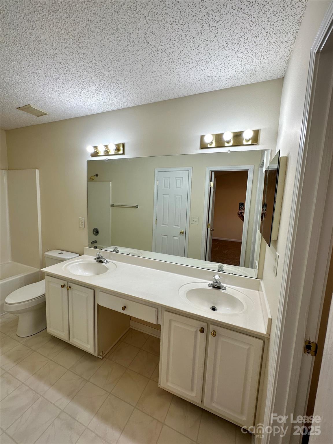 8348 Rudolph Road Charlotte, NC 28216 - Photo 8 of 14 a spacious bathroom with a double vanity sink and mirror