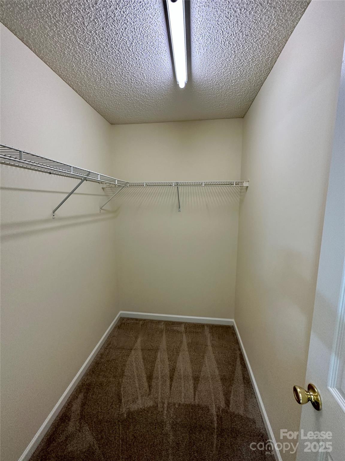 8348 Rudolph Road Charlotte, NC 28216 - Photo 9 of 14 a view of a room with racks on the wall