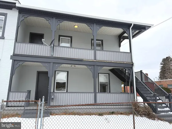 a view of house with wooden fence