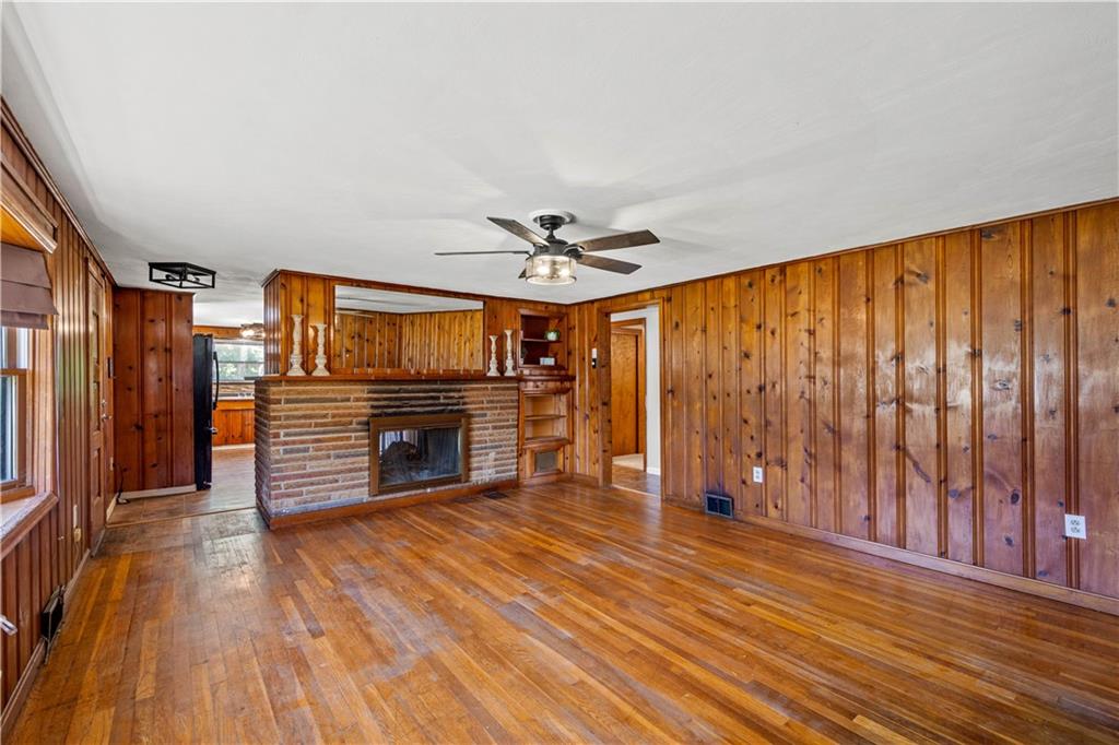 561 Allendale Road New Brighton, PA 15066 - Photo 7 of 25 a view of a livingroom with wooden floor a ceiling fan and staircase