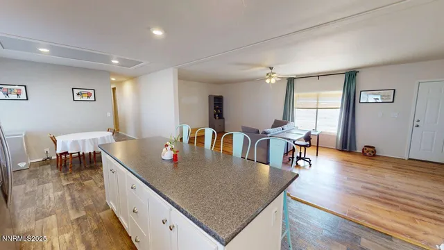 a dining room with table chairs and wooden floor