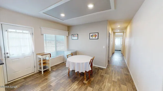a view of a room with furniture and wooden floor