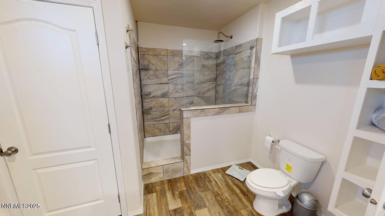 1930 Moccasin Road Battle Mountain, NV 89820 - Photo 23 of 36 a bathroom with a granite countertop toilet a sink and a mirror